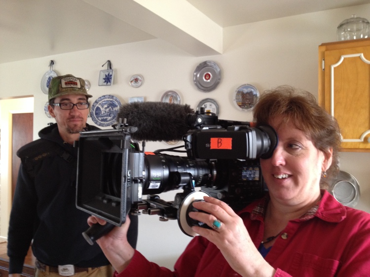 Jolynn Powers holding television camera from the Barnwood builders crew Aug 2015