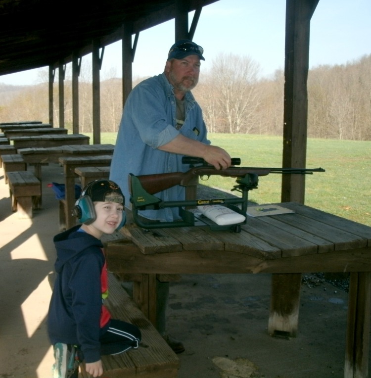 Tom Powers teaching Christopher Powers about gun safty