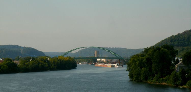Barge moving slowly up the Ohio River from Wheeling to Wirton West Virginia