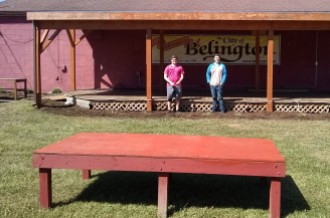 two mormon missionaries help to paint a lovcal stage